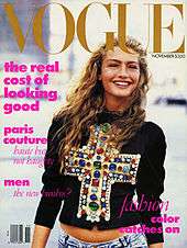 November 1988 cover of American Vogue magazine, showing model Michaela Bercu, shot from just below the waist in natural outdoor light, wearing a $10,000 jewel-encrusted Christian LaCroix T-shirt with faded 450 jeans. The top headline on the cover reads "The real cost of looking good"