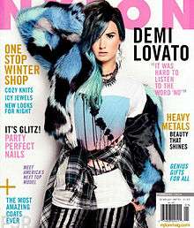 Nylon magazine cover, featuring Demi Lovato with blue hair in faux-fur.