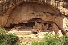 A color picture of a large sandstone cliff dwelling