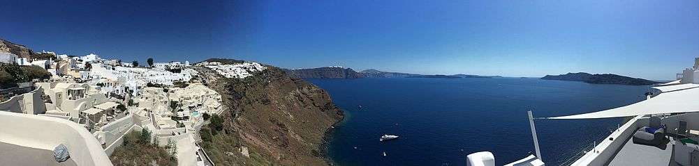  Panoramic view from Oia's cliffs, overlooking the island of Santorini, Thira, Volcano (Palia & Nea Kameni) and beyond.