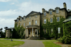 Front facade of Old Government House with circular driveway leading to front door