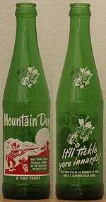 Two old green bottles of Mountain Dew. Left bottle is front cover; right bottle is back cover.