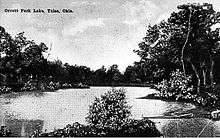 black and white image of a lake surrounded by trees