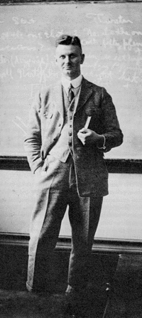 Photograph of Otto Plath standing in front of a blackboard in 1930