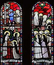 church stained glass window depicting the martyrdom of a line of nuns
