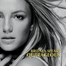 The headshot of a young blonde woman. Her hair is blond and feathered straight. She is wearing lipstick and makeup. Her mouth is slightly open and her hand is pressed against her neck. In the bottom, the words "Britney Spears" are written in yellow italics. Below, the word "Outrageous" is written in the same fashion.