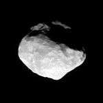 An irregularly shaped body illuminated from the left. Its surface is covered by numerous impact craters.