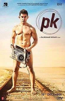 Khan, as the title character PK, stands nude on the railroad tracks, looking into the camera while obscuring his genitals with a cassette tape player.