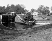 This shows the tailgate of the lock and the attractive (and functional) overflow weir. About 200 years below Papercourt Lock, Broadmead Cut, which has been accompanying us nearby to the north, re-enters the 'wild' River Wey, which then rejoins the navigation, and for about five hundred yards, the navigation is occupying the natural course of the River Wey.