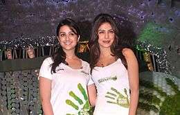 Parineeti and Priyanka Chopra are looking towards the camera.