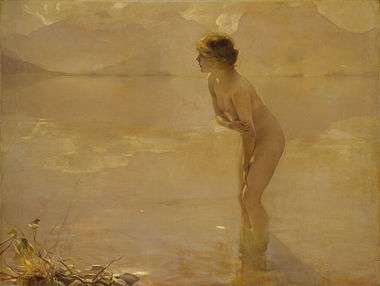 A nude woman standing along the beach