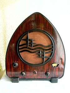 Curved, triangular radio with brown wooden cabinet