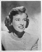 Phyllis Thaxter smiling and looking off to her left in a press head shot from 1955.