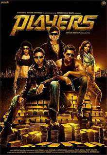 5 people are seen in the poster, three men and two women. Two of the men are sitting atop of gold bricks, holding guns. The other three are standing behind them. Both women are wearing revealing tops, showing their torso, one of them also has a gun in her hand.