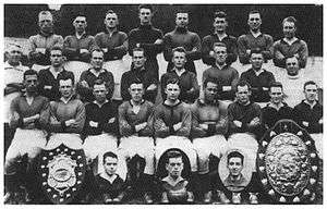 A group of footballers posing for a team photograph.