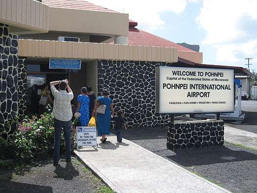 Signage for travelers at Pohnpei International Airport in official English and in Japanese (upper left).