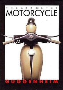 Postcard with legends saying "The Art of the Motorcycle" and "Guggenheim", and a top view of the gas tank, handlebars and front fender of an Art Deco styled motorcycle.