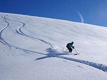 Skier descending a snowy slope near Chamonix