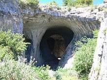 A wide and high entrance to a cave