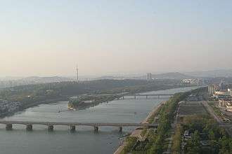 Pyongyang cityscape with the Ongnyu bridge crossing the Taedong river on the foreground