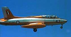 Side view of two-seat, single-engined military jet in flight with wheels down