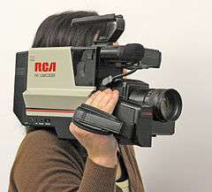 Large shoulder-mount camcorder, hiding operator's face