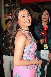 Rani Mukerji is dressed in a pink saree and is laughing cheerfully