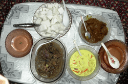 four dishes traditionally eaten during Hari Raya Puasa or Hari Raya Haji are seen laid out on a table.