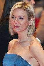 Profile of a female with short blonde hair wearing an azure dress.