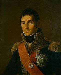 Painting of a man in an elaborate dark blue military uniform of the Napoleonic era. There is a red sash over his shoulder, lots of gold lace on the high collar and epaulettes.