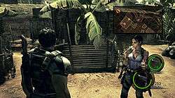 Still from the game with Chris Redfield (back to player) and Sheva Alomar (facing the player)