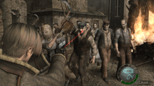 An image of a young man defending himself against a horde of humanoid enemies in a village setting. The camera is behind the man's shoulder, placing him in the bottom left corner and the attackers in the background of the picture.