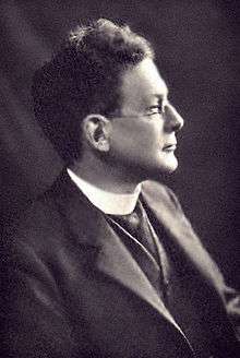head and shoulders shot, right profile, of man in middle age, wearing a clerical collar