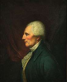 Portrait of a determined-looking man with white hair. He looks to the viewer's left with his head in profile.