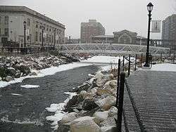 Partially-frozen river running through an urban area