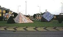 A roundabout featuring geometrical sculptures fashioned from road signs