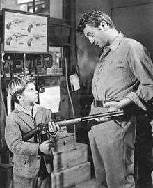 Black and white promotional image of Tommy Rettig and Robert Mitchum in the 1954 film River of No Return