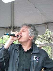 Pollard singing into a microphone