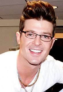 A close-up of Robin Thicke, smiling towards the camera.