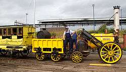 Antique yellow locomotive with engineer