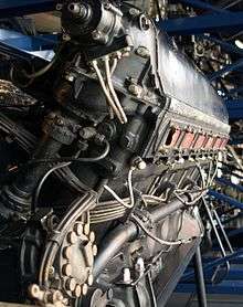 A rear view of the right side of an aircraft piston engine with details of pipes and electrical wiring