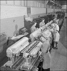 An image of workers on an engine assembly line
