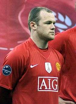 A man named Wayne Rooney lining up wearing Manchester United's jersey; the FIFA Club World Cup badge is clearly visible on the jersey.