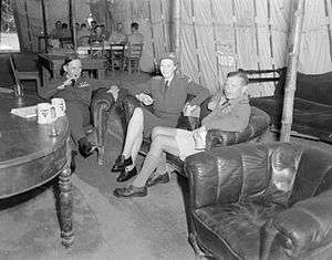 Air Marshal Sir Arthur Tedder (left), Lady Tedder, and Air Vice-Marshal R. M. Foster, Air Officer Commanding the Desert Air Force, in the Officers' Mess of No. 8 Wing SAAF at Campoformido, Udine, Italy.