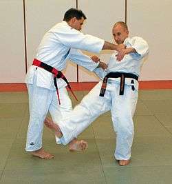 Judoka demonstrating Kosoto-gari technique