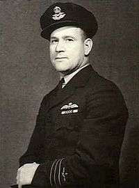 Half portrait of man in dark military uniform with peaked cap