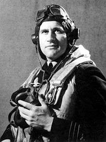 Half portrait of man in dark military uniform with life vest, flying cap, goggles and oxygen mask