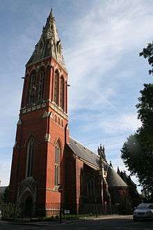 Red brick church with tall spire