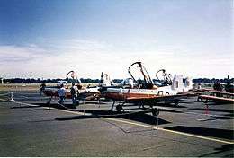 Single-engined military monoplanes with open canopies parked on an airfield