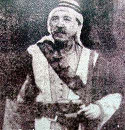 Grainy photo of mustachioed man in traditional dress